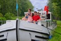 Family vacation, travel on barge boat in canal, parents with kids having fun on river cruise