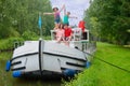 Family vacation, travel on barge boat in canal, parents with kids having fun on river cruise