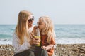 Family vacations child drinking smoothie with mother on beach travel outdoor healthy lifestyle Royalty Free Stock Photo