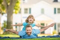 family value. childhood and parenthood. parent rest with little child boy on grass