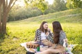 Family value. Two sisters in the Park on the grass with copyspace