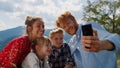 Family video call nature at sunny day. Parents with children using cellphone. Royalty Free Stock Photo