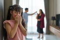 Family violence and family conflict concept, sad little girl with blur of mother fighting father with quarrel at home Royalty Free Stock Photo
