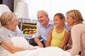 Family Visit To Grandmother In Hospital Bed Royalty Free Stock Photo