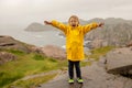 Family visiting the Lindesnes Fyr Lighthouse in Norway on a rainy cold day