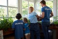 Family volunteers taking care of plants in orangery