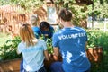 Family volunteers taking care of plants outdoors