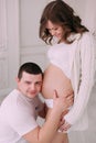 Family waiting for baby`s birth. A pregnant woman and her husband wearing white clothing Royalty Free Stock Photo