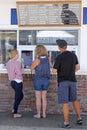 Family waiting for ice cream at street-side ice cream store in Carlsbad, California