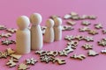 Family is waiting for the new year. wooden figurines of papa`s mom and two children on a pink background with Christmas Royalty Free Stock Photo