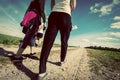 Family walk in countryside on a sunny day. Legs perspective. Vintage look