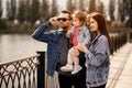 Family walk, father and mother hold their daughter in their arms, the family walks near the river, sunset Royalty Free Stock Photo