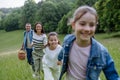 Family on walk in forest, going through meadow. Picking mushrooms, herbs, flowers picking in basket, foraging. Concept