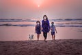 Family walk on the ocean at sunset. Royalty Free Stock Photo