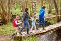 Family Walking Across Wooden Bridge Over Stream In Forest Royalty Free Stock Photo