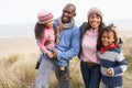 Family Walking Along Dunes On Winter Beach Royalty Free Stock Photo