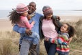 Family Walking Along Dunes On Winter Beach Royalty Free Stock Photo