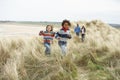 Family Walking Along Dunes On Winter Beach Royalty Free Stock Photo