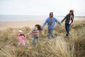 Family Walking Along Dunes On Winter Beach Royalty Free Stock Photo