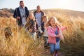 Family Walking Along Path Through Sand Dunes Together Royalty Free Stock Photo