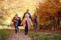 Family Walking Along Track In Autumn Countryside With Children Running Ahead Royalty Free Stock Photo