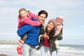 Family Walking Along Winter Beach Royalty Free Stock Photo