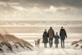 Family walking along in winter beach Royalty Free Stock Photo