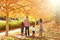 Family walking in an autumn park Royalty Free Stock Photo