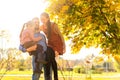 Family walking in autumn park at sunset Royalty Free Stock Photo