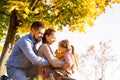 Family walking in autumn park at sunset Royalty Free Stock Photo