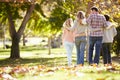 Family Walking Through Autumn Woodland