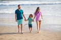 Family walking on beach. Mother father and child son spending time together. Family summer vacation. Parent dad mom Royalty Free Stock Photo