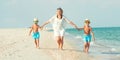 Family walking on the beach Mother and two sons. Royalty Free Stock Photo