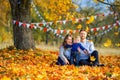 Family walking in beautiful autumn park, sitting on grass and playing Royalty Free Stock Photo