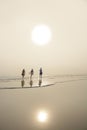 Family walking on the beautiful beach at sunrise. Royalty Free Stock Photo