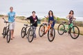 Family walking with bicycles and looking at the camera Royalty Free Stock Photo