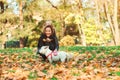 Family walking with dog in autumn park. Mother and daughter having fun together outdoors Royalty Free Stock Photo