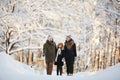 Family Walking Dog in Winter Park Royalty Free Stock Photo