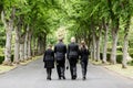 Family walking down alley at graveyard