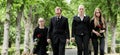 Family walking down alley at graveyard Royalty Free Stock Photo