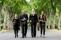 Family walking down alley at graveyard