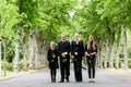 Family walking down alley at graveyard Royalty Free Stock Photo