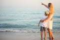 Family walking on the evening beach during sunset. Royalty Free Stock Photo