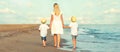 Family walking on the evening beach during sunset. Royalty Free Stock Photo