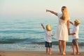 Family walking on the evening beach during sunset. Royalty Free Stock Photo