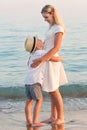 Family walking on the evening beach during sunset.Mother and son embracing, looking at the sea. Royalty Free Stock Photo