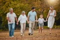 Family, walking and holding hands outdoor with mother, dad and girl happy with grandparents. Happy family, love and Royalty Free Stock Photo