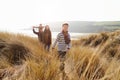 Family Walking Through Sand Dunes On Winter Beach Royalty Free Stock Photo