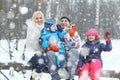 Family walking in snowy park Royalty Free Stock Photo