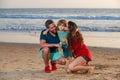 Family walking to the beach on a sunny day. Sea vacation. Parents and children hugging at ocean shore at sunset. Summer Royalty Free Stock Photo